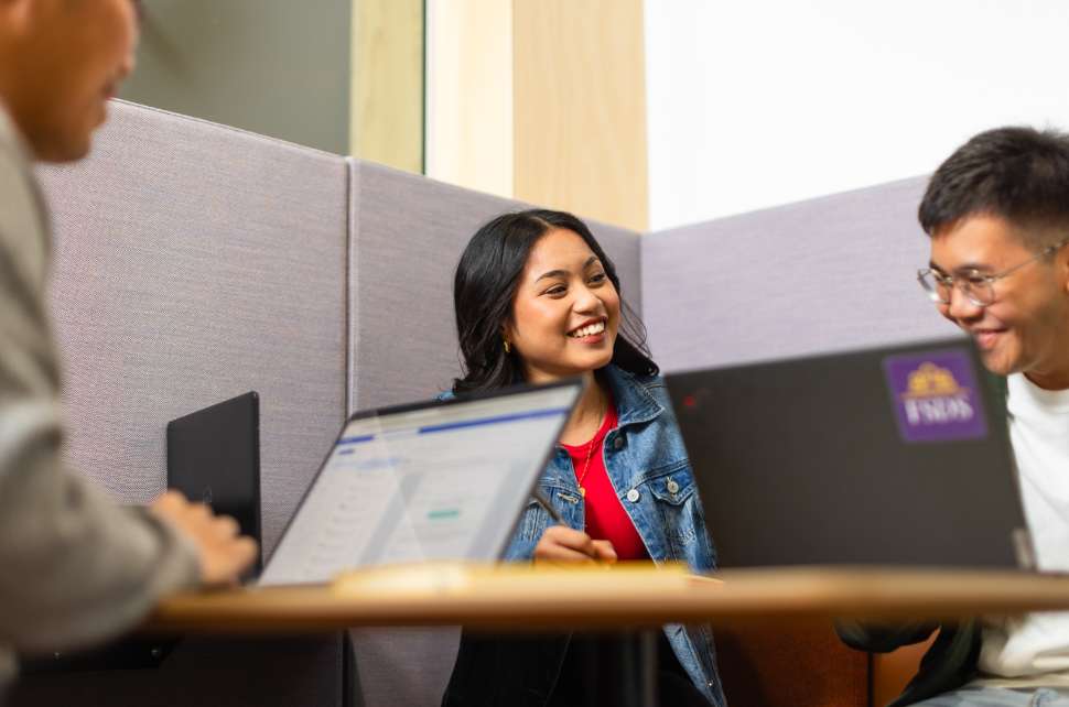 Flinders students talking in the library