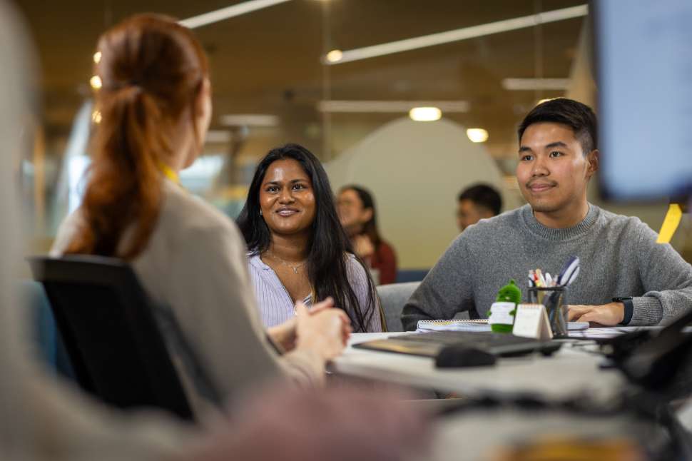 Flinders students talking in the library