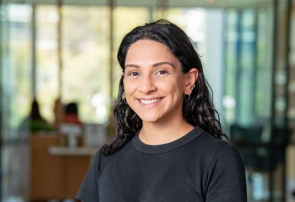 Portrait of Vanshika Sinh smiling in a university building
